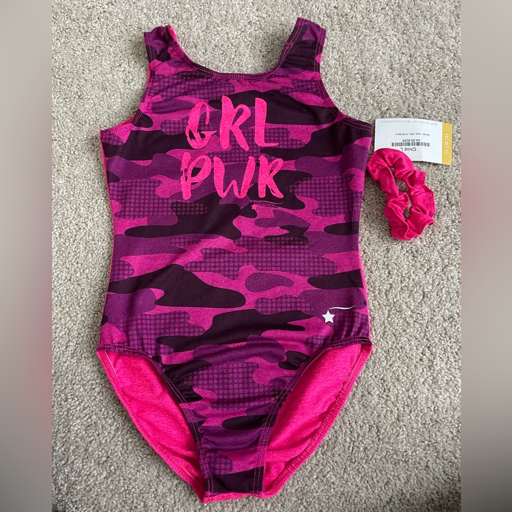 Never worn Destira leotard in size child large with pink scrunchie